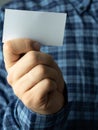 Colorful blank. a man in a plaid shirt puts a business card in his shirt pocket. Royalty Free Stock Photo