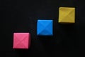 Colorful blank origami paper cubes for creative notes and any idea concept on black background. Business plans and strategy.