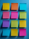 Colorful blank sticky notes arranged in a grid pattern on a blue background ready for creative ideas and reminders in office or Royalty Free Stock Photo