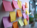 Colorful blank sticky notes arranged on a wall in an office setting ready for brainstorming and creative idea planning sessions Royalty Free Stock Photo