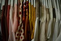 colorful blouses hanging on white hangers, arranged by color