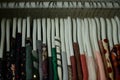 colorful blouses hanging on white hangers, arranged by color