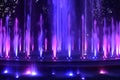 Colorful purple, pink blue color water jets at public fountain Royalty Free Stock Photo