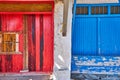 Colorful blue, red boat garage doors, Klima fishermen village, Greece. Painted and weathered wooden doorways Royalty Free Stock Photo