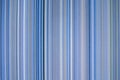 colorful blue toned fabric background with soft faded rainbow-colored vertical stripes