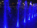 Colorful Blue Water Fountain Jets at Night Royalty Free Stock Photo