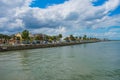 Colorful boardwalk, palm trees and partial view of Castillo de San Marcos Fort in Florida`s Historic Coast . Royalty Free Stock Photo