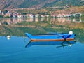 Colorful boat and its reflection on calm water, lake Orestiada, Kastoria Greece