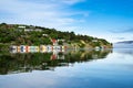 Colorful Boat Sheds with beautiful reflection on daytime  at Duvauchelle, Akaroa Harbour on Banks Peninsula in South Island, New Royalty Free Stock Photo