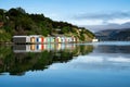 Colorful Boat Sheds with beautiful reflection on daytime  at Duvauchelle, Akaroa Harbour on Banks Peninsula in South Island, New Royalty Free Stock Photo