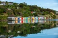 Colorful Boat Sheds with beautiful reflection on daytime  at Duvauchelle, Akaroa Harbour on Banks Peninsula in South Island, New Royalty Free Stock Photo