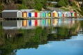 Colorful Boat Sheds with beautiful reflection on daytime  at Duvauchelle, Akaroa Harbour on Banks Peninsula in South Island, New Royalty Free Stock Photo