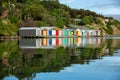 Colorful Boat Sheds with beautiful reflection on daytime  at Duvauchelle, Akaroa Harbour on Banks Peninsula in South Island, New Royalty Free Stock Photo