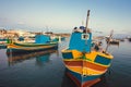 Colorful boats of fishermen in harbor of Malta. Evening over small Mediterranean town Royalty Free Stock Photo