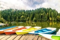 Colorful boats on the lake with the reflection of green trees in Lacu Rosu, Romania Royalty Free Stock Photo