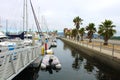 Colorful boats in marina with clouded skies and blue sky peeking out from behind the clouds