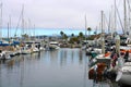 Colorful boats in marina with clouded skies and blue sky peeking out from behind the clouds