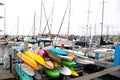 Colorful boats in marina with clouded skies and blue sky peeking out from behind the clouds