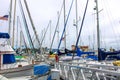 Colorful boats in marina with clouded skies and blue sky peeking out from behind the clouds