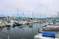 Colorful boats in marina with clouded skies and blue sky peeking out from behind the clouds