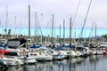 Colorful boats in marina with clouded skies and blue sky peeking out from behind the clouds