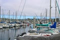 Colorful boats in marina with clouded skies and blue sky peeking out from behind the clouds