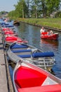 Colorful boats at the quayside of the canal in Giethoorn