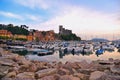 Colorful boats and seascape with old castle and blue cloudy sky with sunset in Lerici in Liguria, Italy