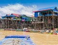 Colorful boats and stilt houses in Kampong Phluk floating village, Tonle Sap lake, Cambodia Royalty Free Stock Photo