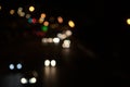 Colorful bokeh of car lights, street lights in black dark night on road in city. Blurry abstract texture background. Royalty Free Stock Photo