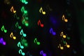 Colorful bokeh on a dark background in the form of musical notes