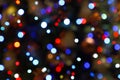 Colorful bokeh lights - big, small, blue, red. Abstract blurred Christmas tree garland lights background. Royalty Free Stock Photo