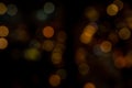 Colorful bokeh with yellow tint as blurry background Royalty Free Stock Photo