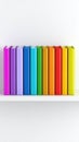 Colorful Books Arranged on White Bookshelf in Rainbow Order for Education Royalty Free Stock Photo