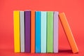 Colorful books with bright hardcovers on red surface. Royalty Free Stock Photo