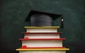 Colorful books forming stairs leading to a mortarboard. 3D illustration