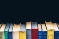 Colorful Books In A Row In Library Or Bookstore On Black Background With Copy-Space Royalty Free Stock Photo
