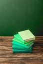 Colorful books on wooden surface isolated on green Royalty Free Stock Photo