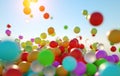 Colorful bouncing balls outdoors against blue sunny sky Royalty Free Stock Photo