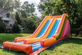 Colorful bouncy castle slide for children playground. Generative AI. Royalty Free Stock Photo