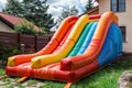 Colorful bouncy castle slide for children playground. Generative AI. Royalty Free Stock Photo