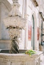 Colorful bouquet of flowers lies on Onofrio small marble fountain. Dubrovnik, Croatia Royalty Free Stock Photo