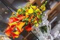 Colorful bouquet of orange calla lilies and other flowers on the table