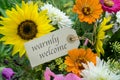 Summer flowers with card and english text:  warmly welcome Royalty Free Stock Photo