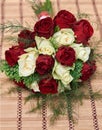 Colorful bouquet of white and red roses on bege bamboo straw mat, close up Royalty Free Stock Photo