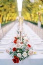 Colorful bouquets stand on a set table in a green garden