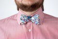 Colorful bow tie with pink shirt.