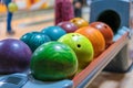 Colorful bowling balls on ball return close up Royalty Free Stock Photo