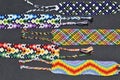 Colorful braided friendship bracelets handmade of thread and knots isolated on black background Royalty Free Stock Photo