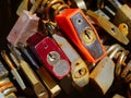 Colorful brass, steel and plastic covered padlocks in close-up view.